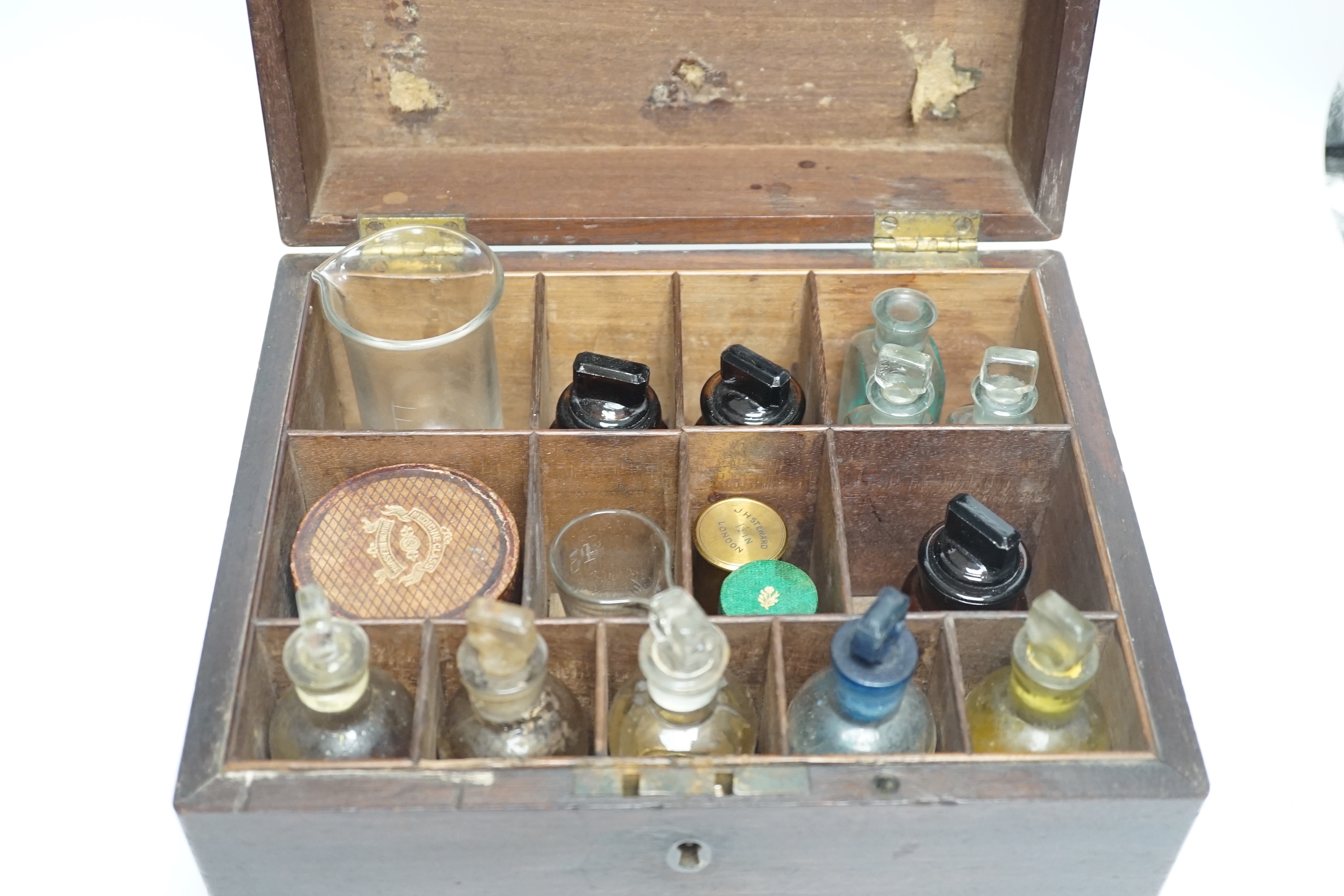 A 19th century mahogany apothecary box and contents, some bottles including Brighton labels, 23cm high x 25.5cm wide